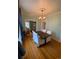 Bright dining room with hardwood floors, modern chandelier, and a view into the living room at 422 E 6Th Ave, Denver, CO 80203