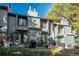 Private backyard featuring patio furniture, lush lawn, and mature trees at 3506 S Depew St # 3, Denver, CO 80235