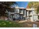 Backyard view of a two-story townhome with a lawn and patio furniture, creating an inviting outdoor space at 3506 S Depew St # 3, Denver, CO 80235