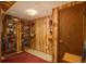 Unique basement with wood paneled walls, guitar decorations, and display cabinets at 3506 S Depew St # 3, Denver, CO 80235