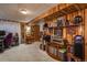 Finished basement with decorative wood paneling, carpet, and shelving units to display collectibles at 3506 S Depew St # 3, Denver, CO 80235