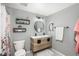 Modern bathroom equipped with a double sink vanity, stylish lighting, and contemporary fixtures at 3506 S Depew St # 3, Denver, CO 80235
