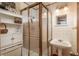 Classic bathroom design featuring a glass shower stall and a neutral color scheme for a clean aesthetic at 3506 S Depew St # 3, Denver, CO 80235