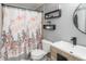Stylish bathroom with patterned shower curtain, modern vanity, and sleek black accents at 3506 S Depew St # 3, Denver, CO 80235
