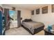 Cozy bedroom with carpeted floors, a telescope by the window, and framed posters on the walls at 3506 S Depew St # 3, Denver, CO 80235
