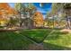 Beautifully landscaped community lawn surrounded by colorful fall trees and greenery at 3506 S Depew St # 3, Denver, CO 80235