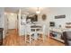 Cozy dining area with wood floors, a round table, and a coffee bar at 3506 S Depew St # 3, Denver, CO 80235