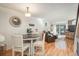 Open floor plan with hardwood floors; dining room view showcases living area and sliding door to back patio at 3506 S Depew St # 3, Denver, CO 80235