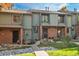 Charming townhouse with brick accents, well-maintained landscaping, and inviting front porch at 3506 S Depew St # 3, Denver, CO 80235