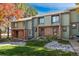 Charming townhome with brick facade, well-manicured lawn, and lovely autumn foliage at 3506 S Depew St # 3, Denver, CO 80235