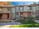 Charming townhome exterior with a brick facade, well-maintained landscaping, and a welcoming entryway at 3506 S Depew St # 3, Denver, CO 80235