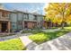 Attractive townhome with brick accents, well-kept lawn, and mature trees at 3506 S Depew St # 3, Denver, CO 80235