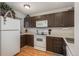 Functional kitchen featuring white appliances, ample cabinet space, and vinyl flooring at 3506 S Depew St # 3, Denver, CO 80235