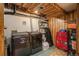 Functional laundry room features modern appliances, storage shelves, and wood paneled ceiling at 3506 S Depew St # 3, Denver, CO 80235
