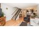 Inviting living room featuring hardwood floors, staircase and cozy furnishings at 3506 S Depew St # 3, Denver, CO 80235