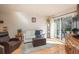 Bright living area with hardwood floors, sliding doors, and comfortable seating creating a cozy atmosphere at 3506 S Depew St # 3, Denver, CO 80235