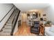 Inviting space with hardwood floors, open staircase, and a glimpse into the kitchen area at 3506 S Depew St # 3, Denver, CO 80235