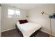 Simple basement bedroom with a double bed and window access at 4632 S Pagosa Cir, Aurora, CO 80015