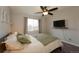 Spacious bedroom with a ceiling fan, large window, and mounted TV at 4632 S Pagosa Cir, Aurora, CO 80015