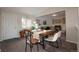 Bright dining area with a rustic wooden table and modern chairs at 4632 S Pagosa Cir, Aurora, CO 80015