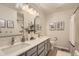 Bright bathroom with double sinks, modern lighting, and sleek cabinets at 10155 Silver Maple Cir, Highlands Ranch, CO 80129