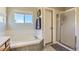 Bright bathroom featuring a tub, shower, and window letting in natural light at 10155 Silver Maple Cir, Highlands Ranch, CO 80129