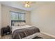 Cozy bedroom with a large window and a comfortable bed with a dark wood frame and soft gray bedding at 10155 Silver Maple Cir, Highlands Ranch, CO 80129