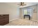 Neutral bedroom showcasing a large window, dresser, and desk at 10155 Silver Maple Cir, Highlands Ranch, CO 80129
