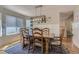 Cozy dining room featuring a wooden table, chandelier, and view into the kitchen at 10155 Silver Maple Cir, Highlands Ranch, CO 80129
