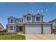Two-story home with a two-car garage, manicured lawn, and brick accents, and an address on the facade at 10155 Silver Maple Cir, Highlands Ranch, CO 80129