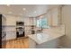 Bright kitchen with white cabinets, quartz countertops, subway tile backsplash, and stainless steel appliances at 10155 Silver Maple Cir, Highlands Ranch, CO 80129