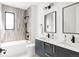 Modern bathroom with double vanity, sleek fixtures, and tiled shower-tub combination for a spa-like experience at 732 S Gaylord St, Denver, CO 80209