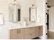 Bright bathroom with double sinks, modern fixtures, and neutral-toned tile at 732 S Gaylord St, Denver, CO 80209