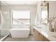 Modern bathroom features a soaking tub, large window, and sleek fixtures at 732 S Gaylord St, Denver, CO 80209
