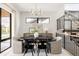 Modern dining area featuring a long black table and wood staircase at 732 S Gaylord St, Denver, CO 80209