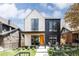 Striking two-story home features a modern black and white design, complemented by a beautifully landscaped front yard at 732 S Gaylord St, Denver, CO 80209