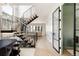 Bright, open foyer with modern staircase and glass door leading to an adjacent room at 732 S Gaylord St, Denver, CO 80209
