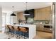 Gourmet kitchen featuring modern bar stools, waterfall island, and state-of-the-art appliances at 732 S Gaylord St, Denver, CO 80209