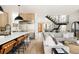 Open-concept living room featuring wood floors, modern staircase, and seamless connection to the gourmet kitchen at 732 S Gaylord St, Denver, CO 80209