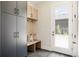 Inviting mudroom features custom cabinets, built-in bench, and a door to the outdoors at 732 S Gaylord St, Denver, CO 80209
