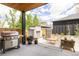 Inviting outdoor patio with a grill, fireplace, dining area, and comfortable seating for relaxation and entertainment at 732 S Gaylord St, Denver, CO 80209