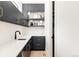 Butler's pantry features dark blue cabinetry, a sink, open shelving and a wine fridge at 732 S Gaylord St, Denver, CO 80209