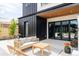 Modern patio with sleek seating, and black-trimmed folding glass doors for seamless indoor-outdoor living at 732 S Gaylord St, Denver, CO 80209