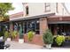 Wash Park Grille with brick facade and large windows adorned with greenery, sidewalk view at 732 S Gaylord St, Denver, CO 80209