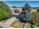 Charming two-story home featuring a well-manicured lawn and mature trees on a sunny day at 3931 Shane Valley Trl, Castle Rock, CO 80109