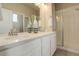 Elegant bathroom with double vanity and a walk-in shower at 6727 Canosa St, Denver, CO 80221