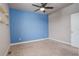 Spacious bedroom with blue accent wall and carpet flooring at 6727 Canosa St, Denver, CO 80221