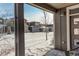 View from covered porch shows a snow-covered street and houses at 6727 Canosa St, Denver, CO 80221