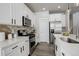 Modern kitchen with white cabinets, stainless steel appliances, and island at 6727 Canosa St, Denver, CO 80221