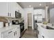 Modern kitchen with white cabinets, stainless steel appliances, and island at 6727 Canosa St, Denver, CO 80221